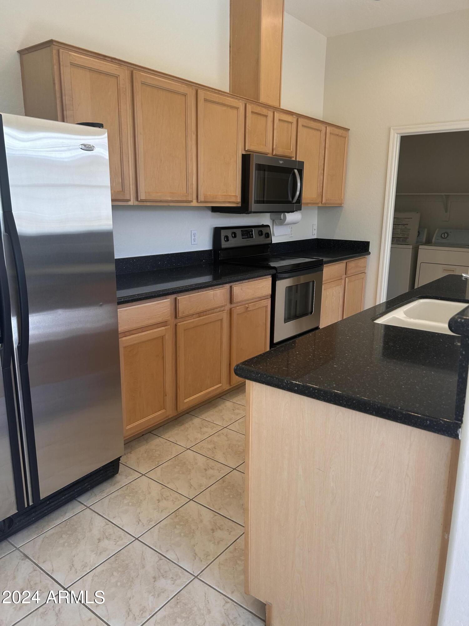 1225 North 36th Street, Unit 2115 Phoenix, AZ 85008 - Photo 3 of 36 a kitchen with stainless steel appliances a microwave a sink and a refrigerator
