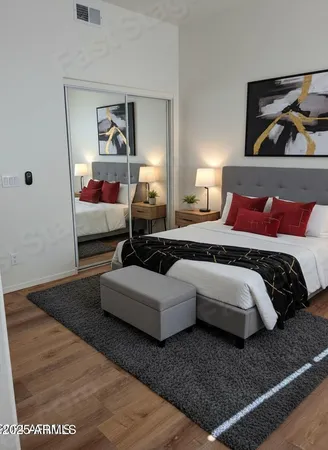 a bedroom with a bed and lamp