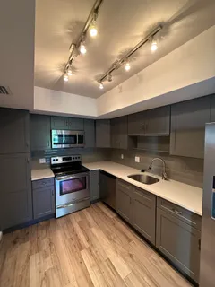 a kitchen with stainless steel appliances granite countertop a sink and stove top oven