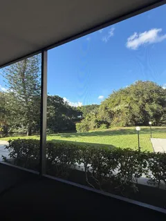 a view of a floor to ceiling room next to a yard