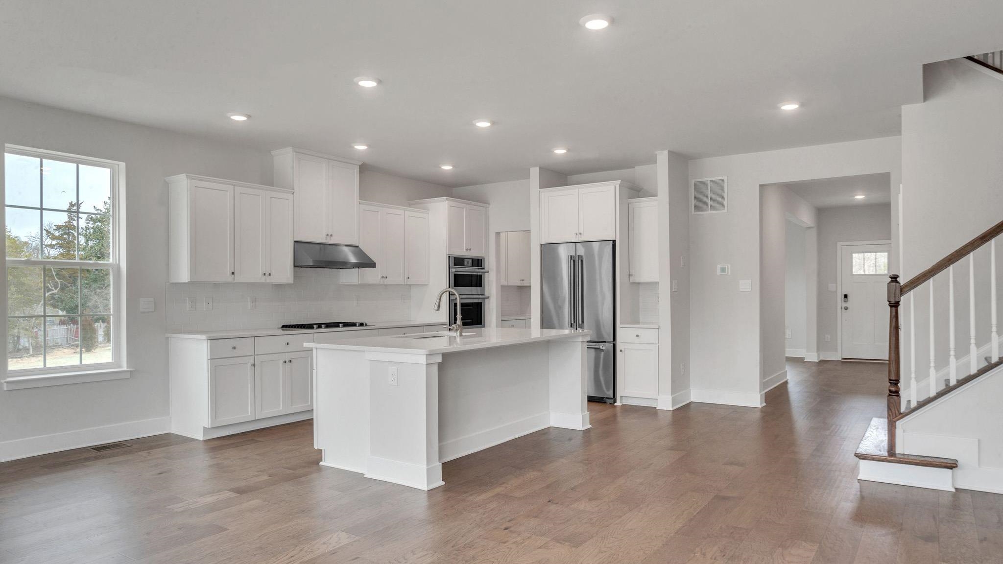 13 Henry Marmora, NJ 08223 - Photo 9 of 21 a large kitchen with stainless steel appliances granite countertop a stove a sink a refrigerator and white cabinets with wooden floor