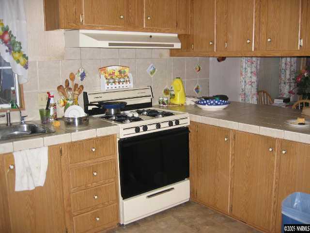 17810 Fantail Circle Reno, NV 89508 - Photo 5 of 9 a kitchen with stainless steel appliances granite countertop a stove a sink and a microwave