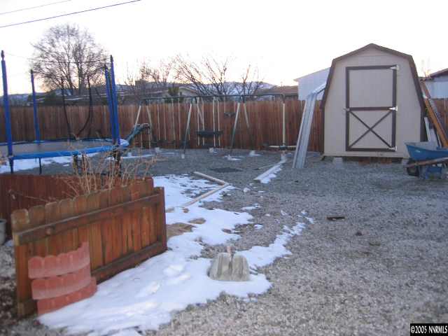 17810 Fantail Circle Reno, NV 89508 - Photo 9 of 9 a view of backyard with table and chairs couches under an umbrella with wooden fence