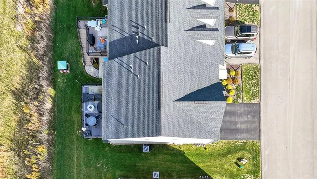 an aerial view of a house with a yard