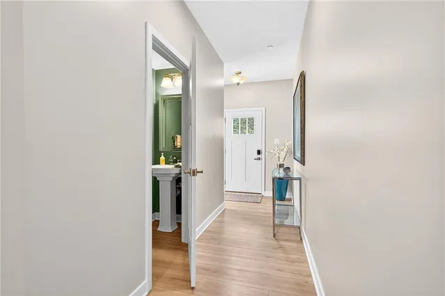 a view of a hallway with wooden floor and staircase