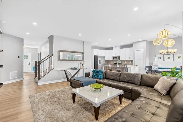 a living room with furniture and a wooden floor