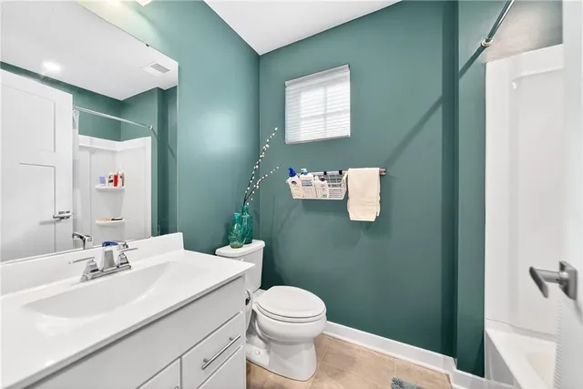 a bathroom with a sink vanity mirror and toilet