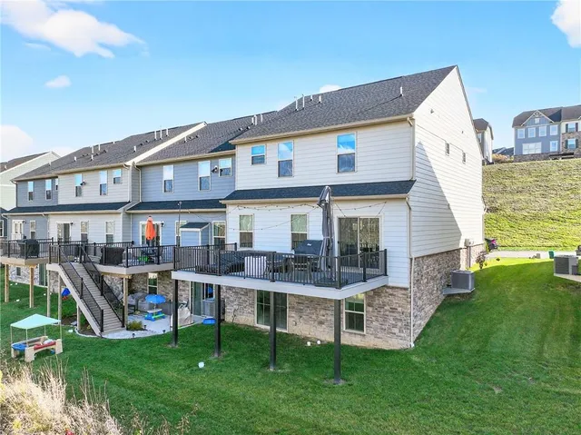 a view of a house with a yard and sitting area