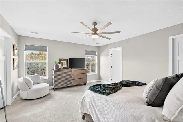 a bedroom with furniture and a flat screen tv
