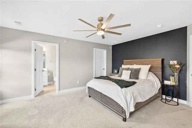 a bedroom with a bed and a ceiling fan