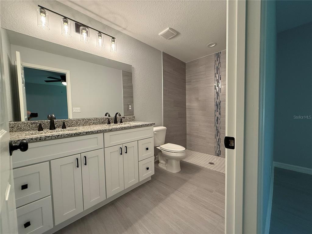 2531 Smallwood Road Dunnellon, FL 34431 - Photo 12 of 15 a spacious bathroom with a double vanity sink a toilet and a mirror