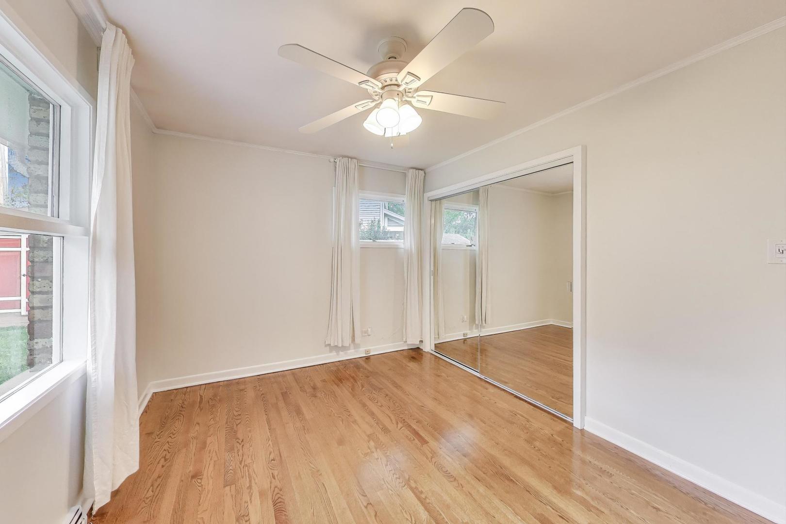 1022 Whitfield Road Northbrook, IL 60062 - Photo 12 of 29 a view of an empty room with wooden floor and a window