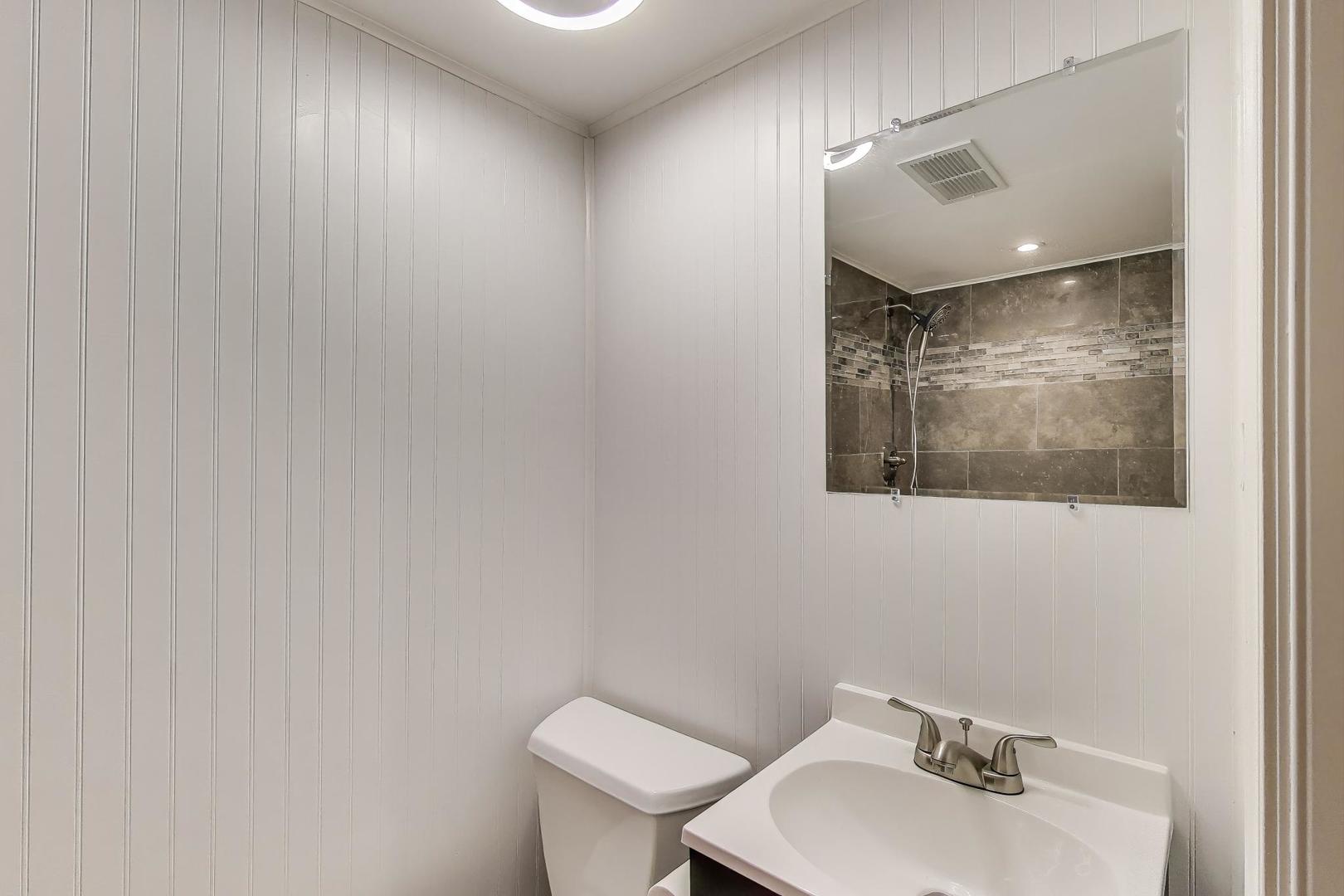 1022 Whitfield Road Northbrook, IL 60062 - Photo 19 of 29 a bathroom with a sink mirror and toilet