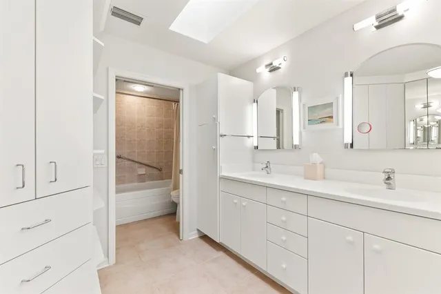 a bathroom with a double vanity sink and mirror