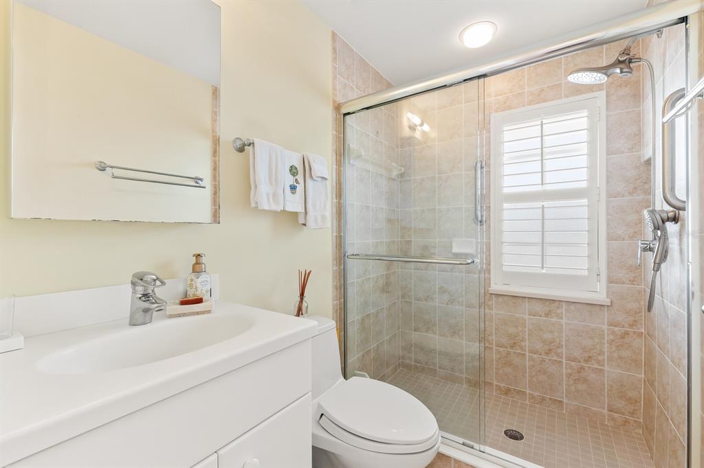 5856 Gasparilla Road, Unit MV26 Boca Grande, FL 33921 - Photo 12 of 38 a bathroom with a sink a toilet and shower