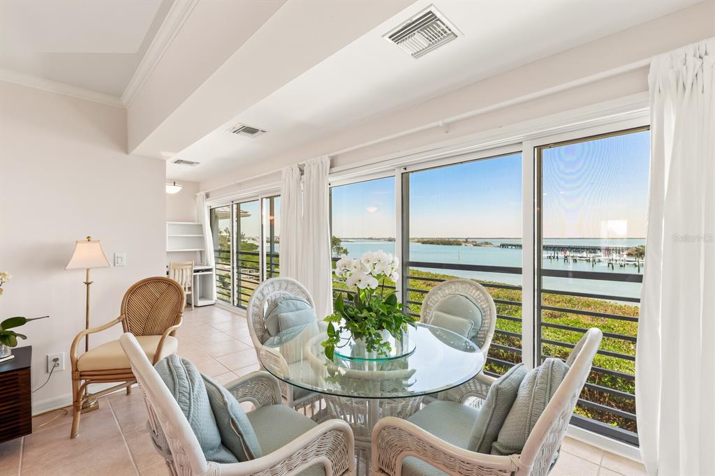 5856 Gasparilla Road, Unit MV26 Boca Grande, FL 33921 - Photo 4 of 38 a view of a dining room with furniture window and wooden floor
