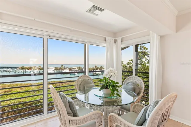 a dining room with furniture a rug and a large window