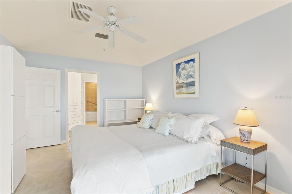 5856 Gasparilla Road, Unit MV26 Boca Grande, FL 33921 - Photo 7 of 38 a bedroom with a bed and a lamp on dresser