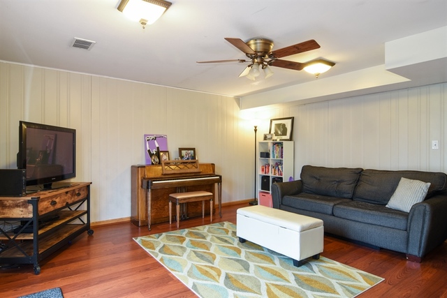 502 South Mt Prospect Road Des Plaines, IL 60016 - Photo 11 of 18 a living room with furniture and a flat screen tv