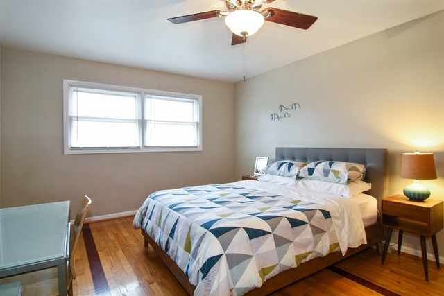 502 South Mt Prospect Road Des Plaines, IL 60016 - Photo 12 of 18 a bedroom with a bed and a chandelier