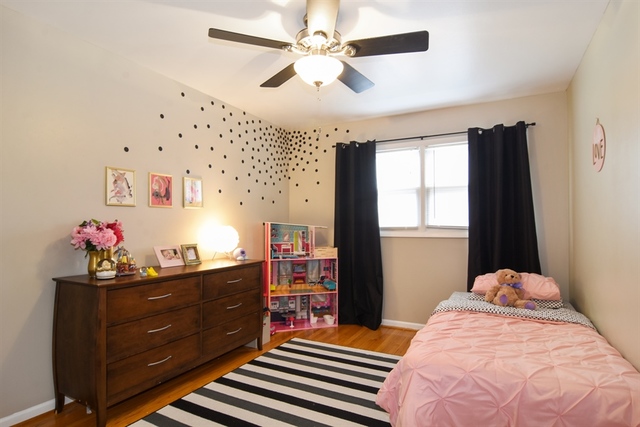 502 South Mt Prospect Road Des Plaines, IL 60016 - Photo 13 of 18 a bedroom with a bed dresser and a window