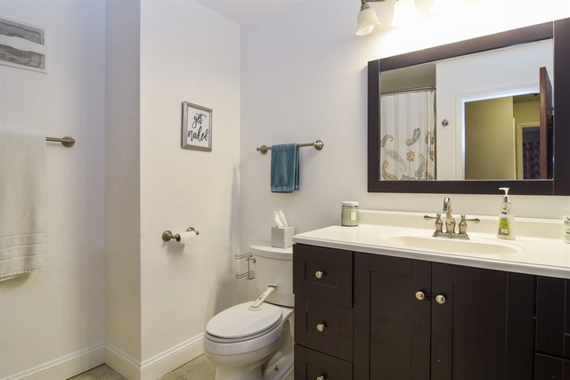 502 South Mt Prospect Road Des Plaines, IL 60016 - Photo 14 of 18 a bathroom with a toilet a sink and mirror