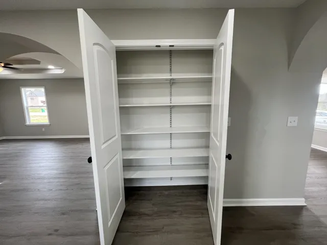 a bathroom with a glass door shower and closet