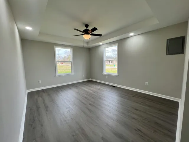 a view of a room with wooden floor and white walls