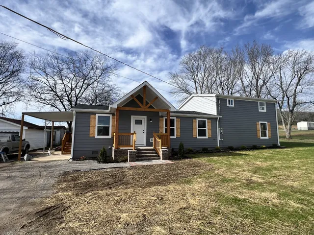 a front view of a house with a yard