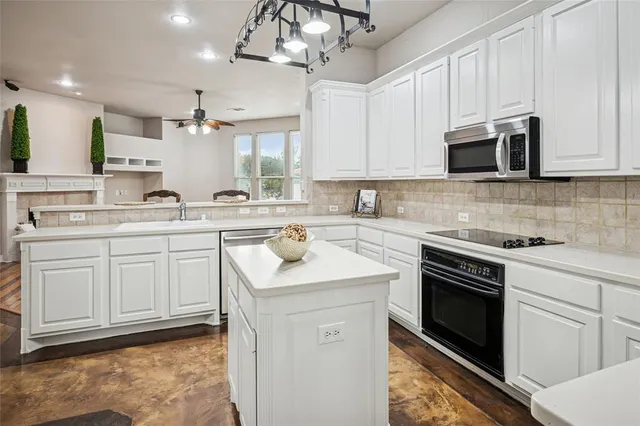 a kitchen with a sink stove and microwave