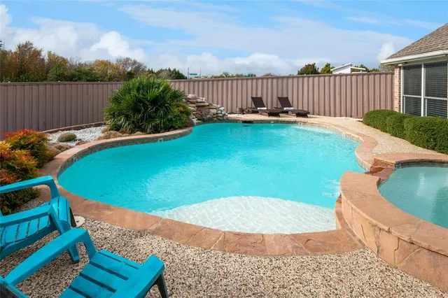 a view of a patio with chairs and umbrellas