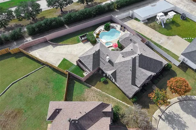 an aerial view of a house with yard swimming pool and outdoor seating