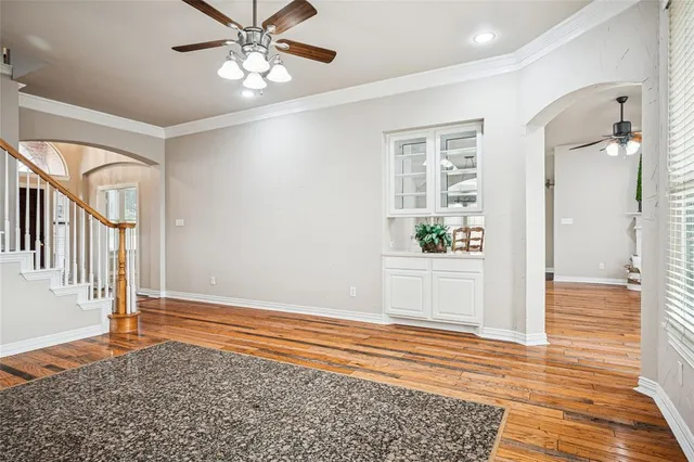 a view of a hallway view with wooden floor and staircase