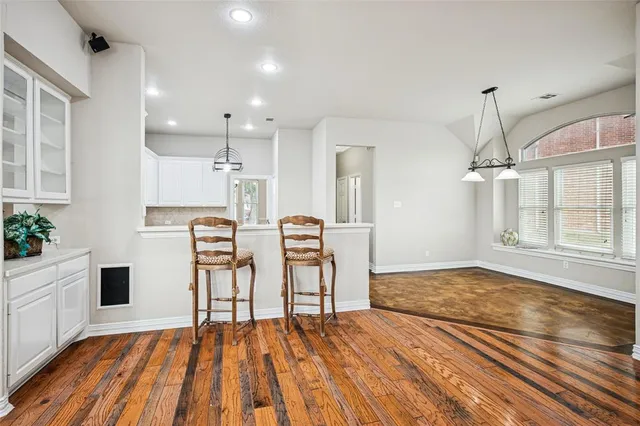 a view of empty room with wooden floor and ceiling fan