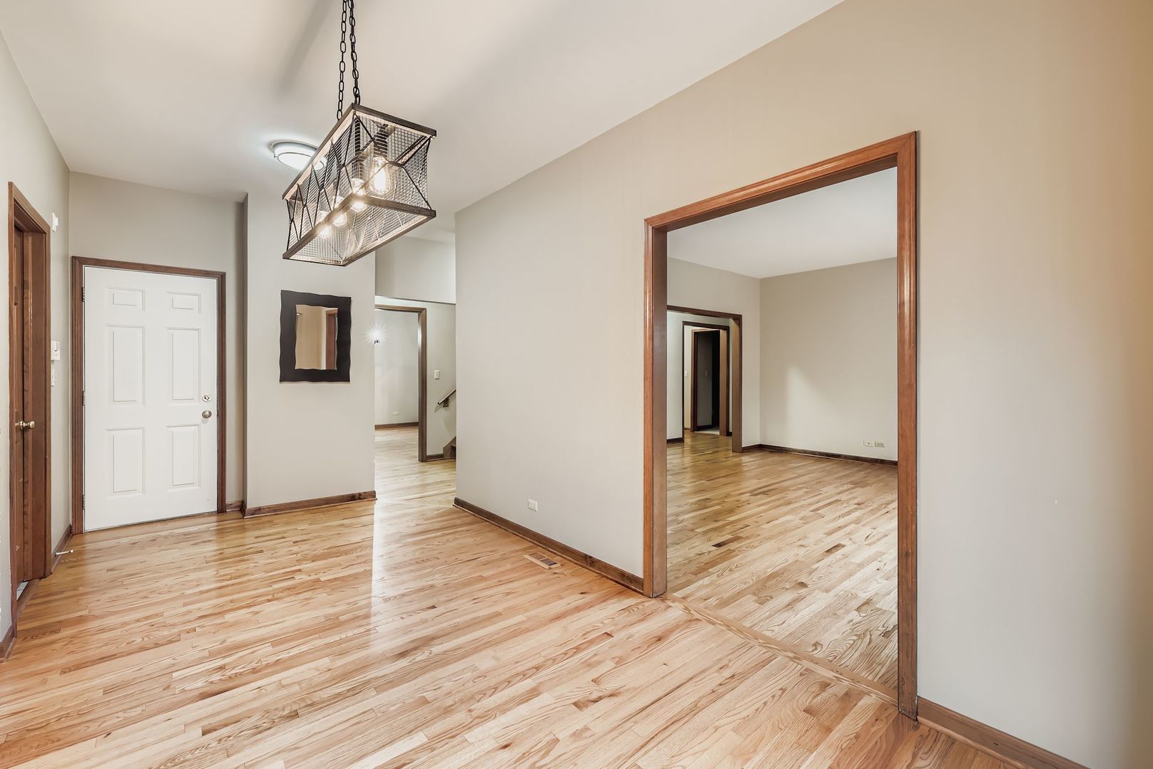 845 Harmon Boulevard Hoffman Estates, IL 60169 - Photo 14 of 33 a view of a hallway with wooden floor and a refrigerator