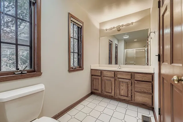 a bathroom with a sink a mirror and a toilet