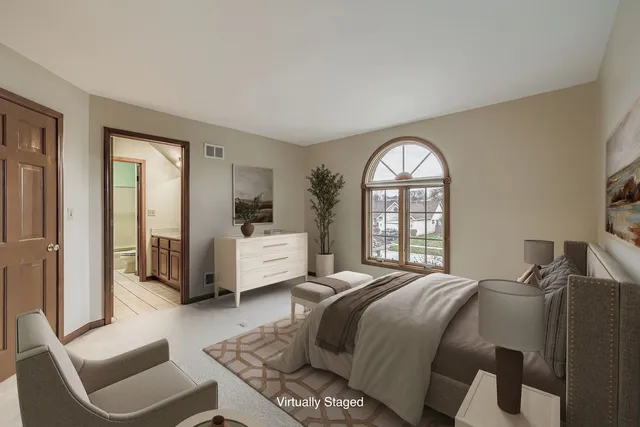 a bedroom with a bed and a large window