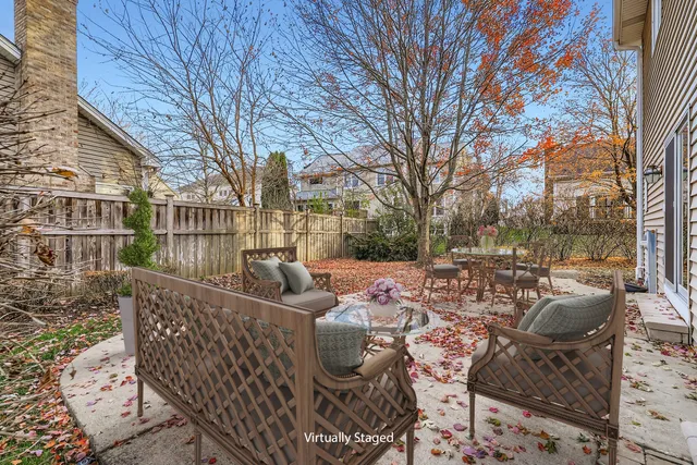 a view of a patio with couches chairs and wooden floor