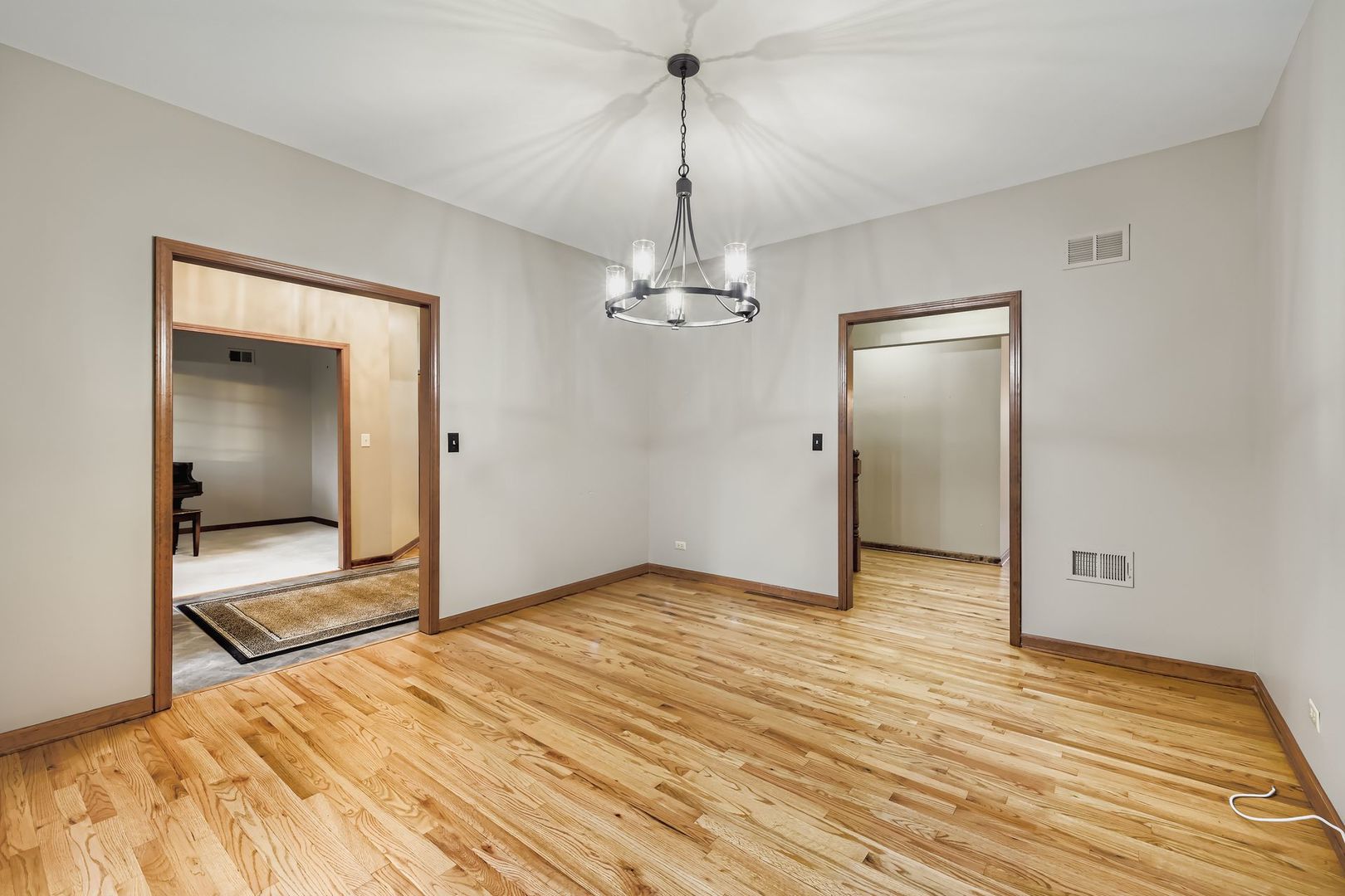 845 Harmon Boulevard Hoffman Estates, IL 60169 - Photo 5 of 33 a view of a room with wooden floor staircase and a hallway