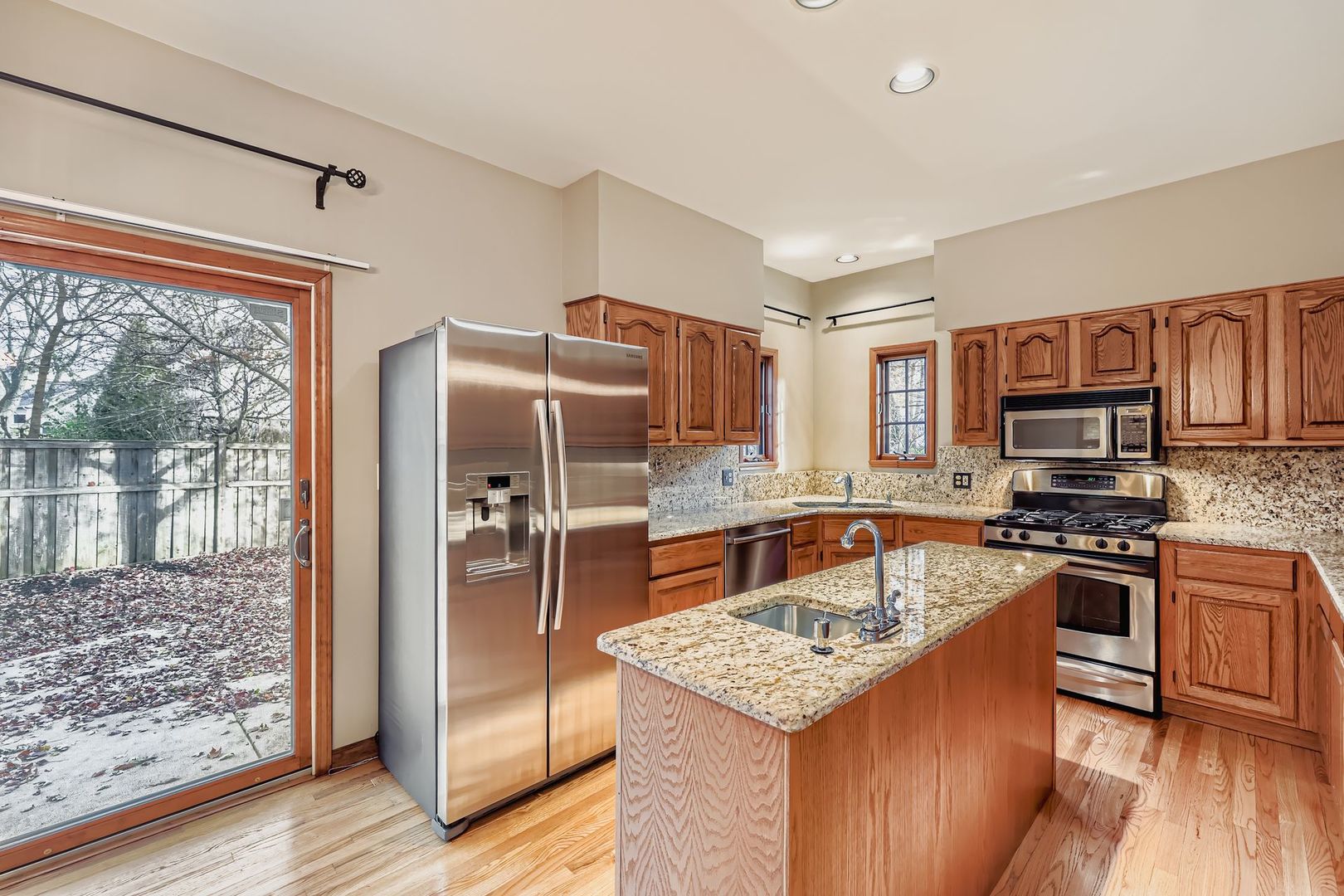 845 Harmon Boulevard Hoffman Estates, IL 60169 - Photo 7 of 33 a kitchen with stainless steel appliances granite countertop a refrigerator stove and sink