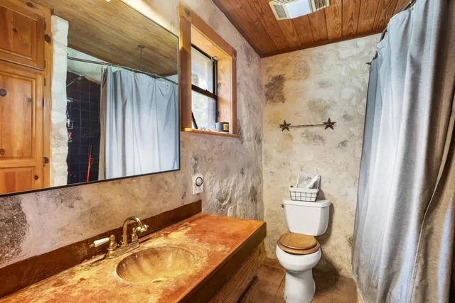 a bathroom with a sink and toilet