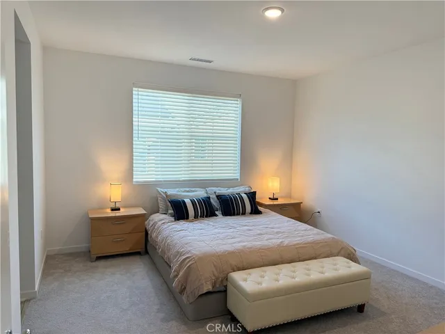 a bedroom with a bed and window