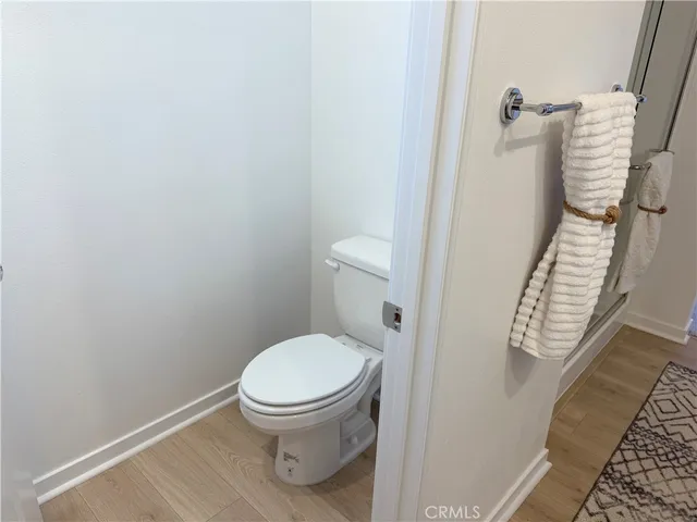 a white toilet sitting next to a shower