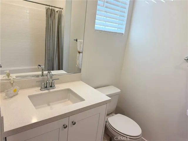 a bathroom with a sink a toilet and vanity