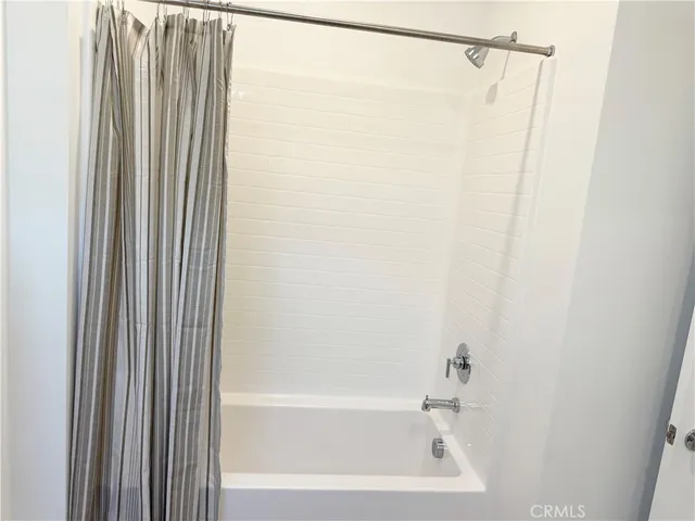 a bathroom with a shower and a bath tub
