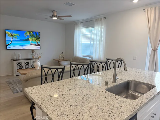 a kitchen with stainless steel appliances granite countertop a sink a stove and island