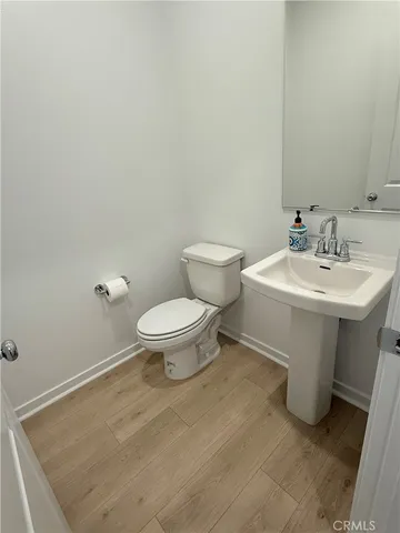 a bathroom with a sink toilet and a mirror