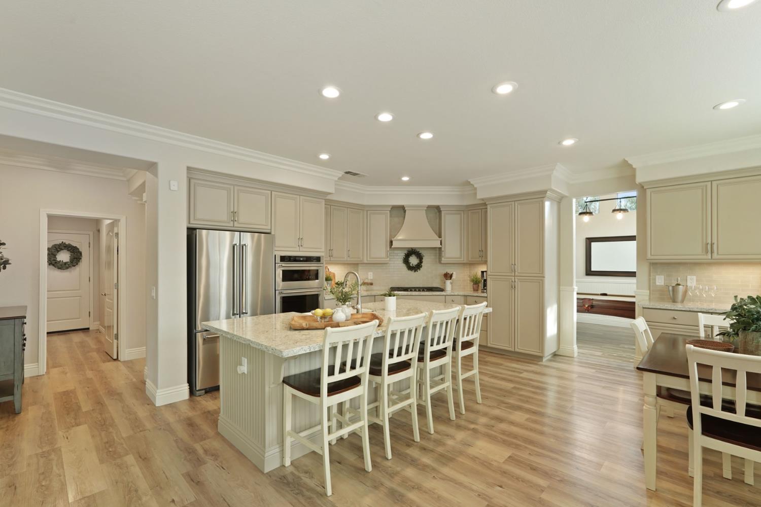 2227 Heavenly Way Lodi, CA 95242 - Photo 21 of 62 a kitchen with stainless steel appliances a dining table chairs and wooden floor