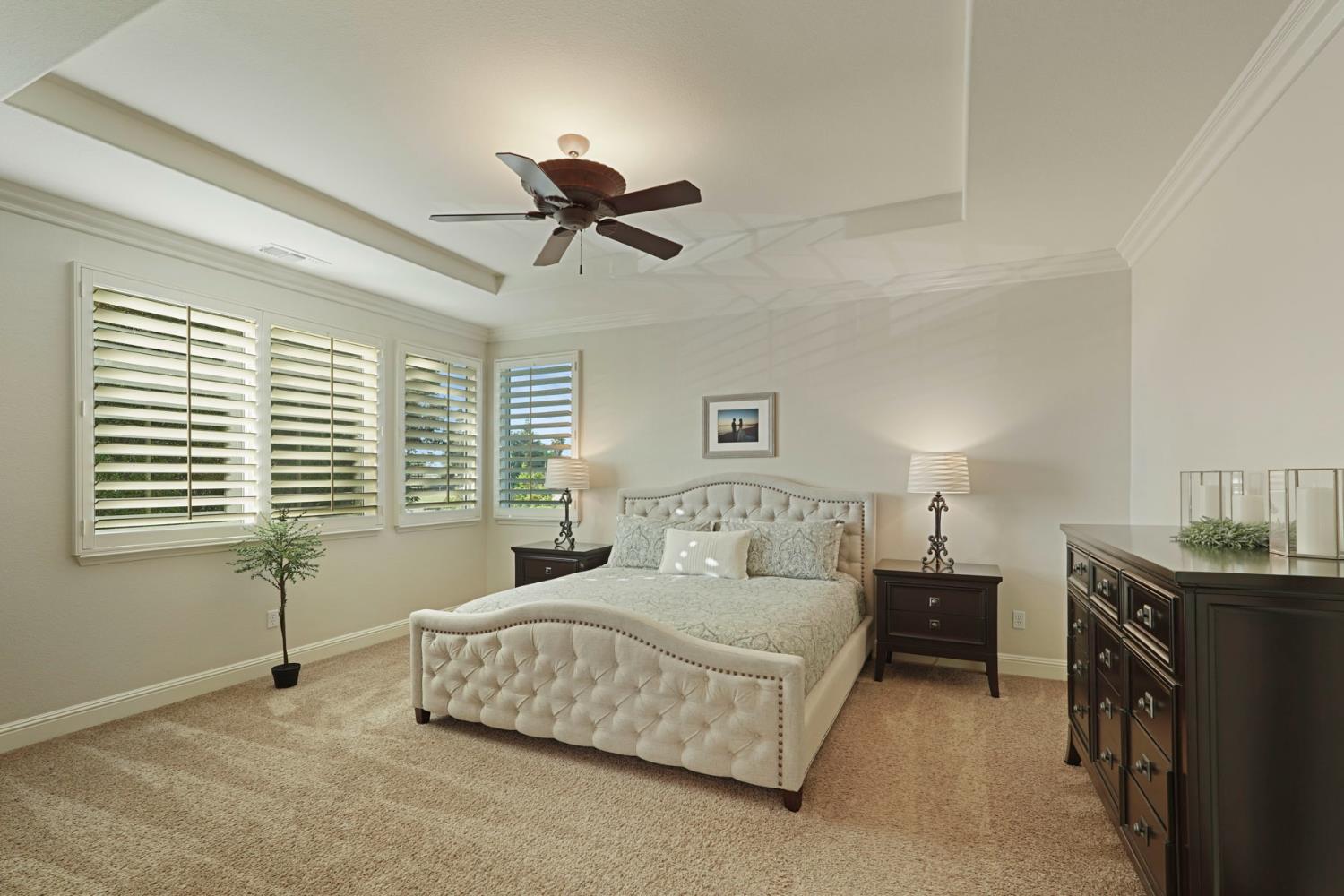 2227 Heavenly Way Lodi, CA 95242 - Photo 37 of 62 a bedroom with a bed a chandelier and a window