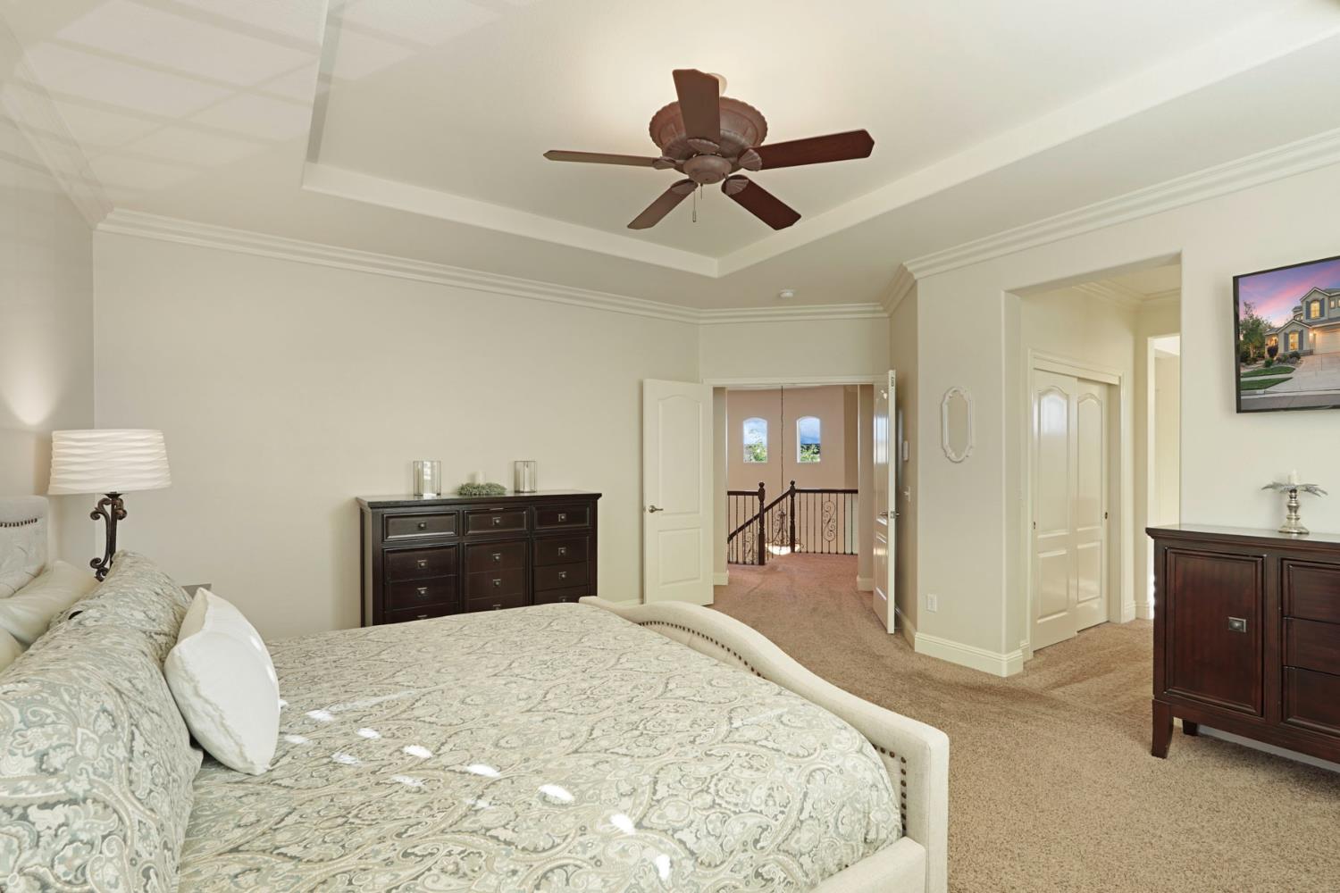 2227 Heavenly Way Lodi, CA 95242 - Photo 39 of 62 a bedroom with a bed and a chandelier